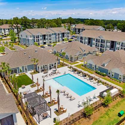 an aerial view of an apartment complex with a swimming pool