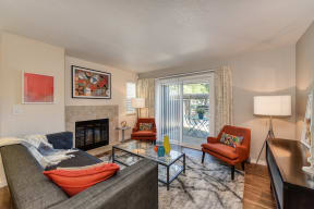 Living Room and Entryway withWood Inspired Floors,  Orange Chair, Hardwood Inspired Floor, Gray Sofa, Black/White Rug 