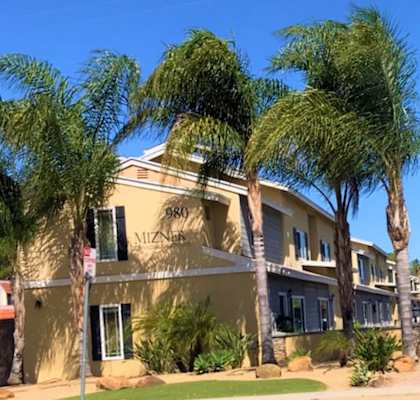 a building with palm trees in front of it