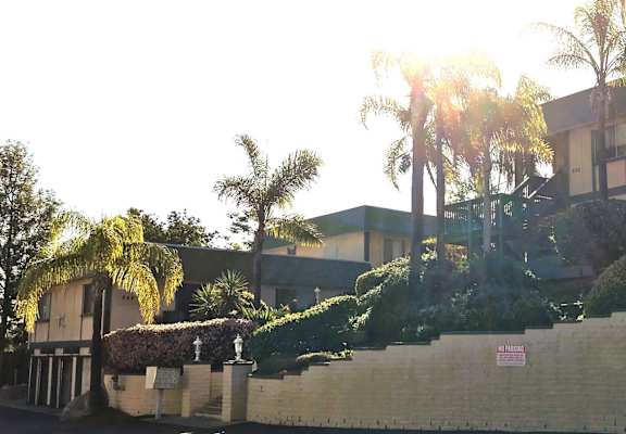 a building with palm trees in front of it