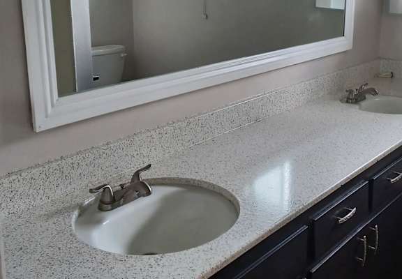 a bathroom sink with a mirror above it