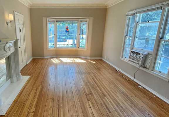 a living room with a fireplace and hardwood floors