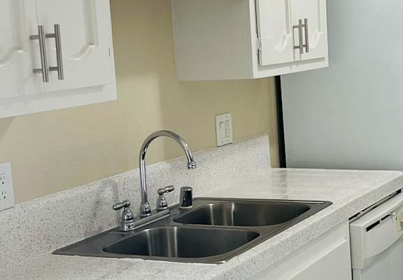 a kitchen with a sink and a refrigerator