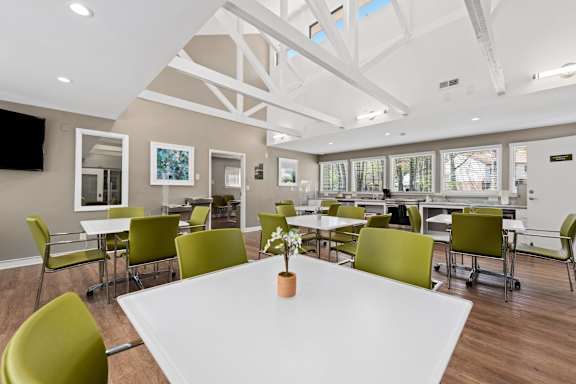 Resident Community Room with TV, Tables and Seating.