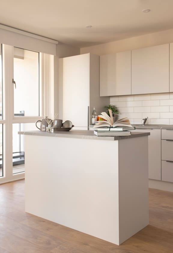 a kitchen with white cabinets and a white counter top