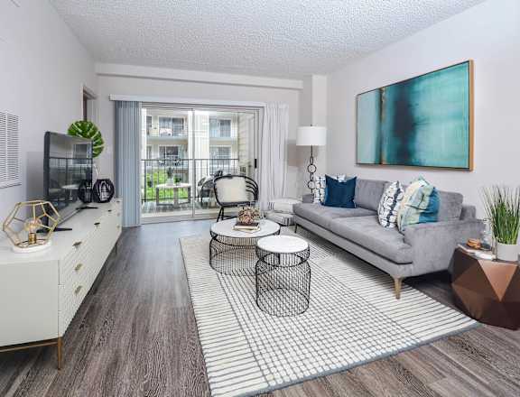 a living room with a couch and a tv at The Citizen at Shirlington Village in Arlington, 22206