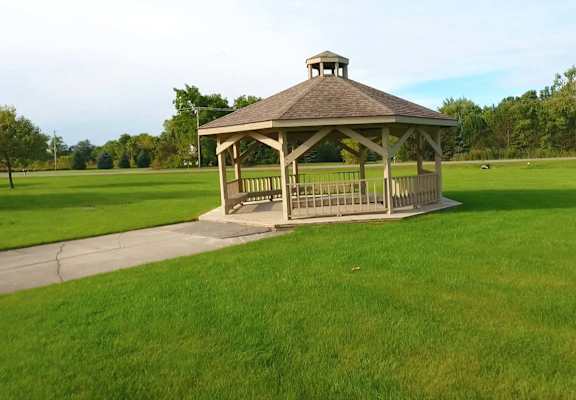 a gazebo in the middle of a grass field
