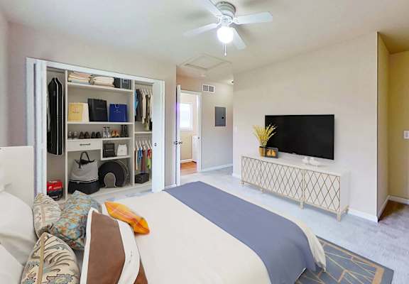 a bedroom with a bed and a tv