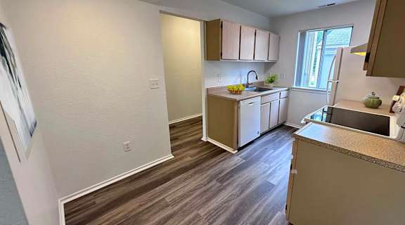 a kitchen with a sink and a refrigerator