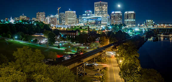 a cityscape at night with a full moon at The Bella at Westchester, Virginia