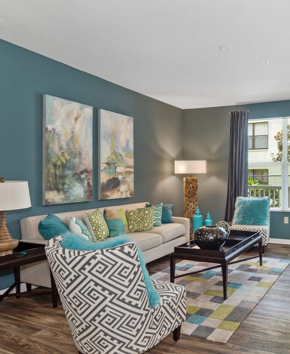 a living room with blue walls and a white couch at The Arbor Walk Apartments, Florida, 33617