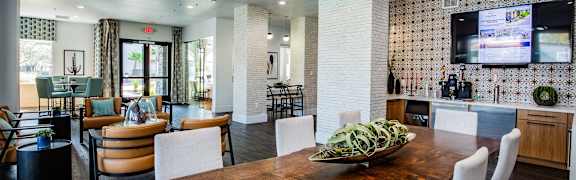 A modern dining room with a wooden table and chairs.