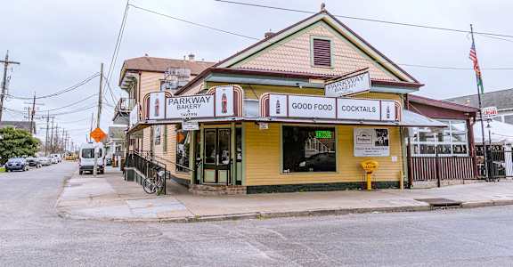 A yellow building with a sign that says Parkway Good Food Cocktails.