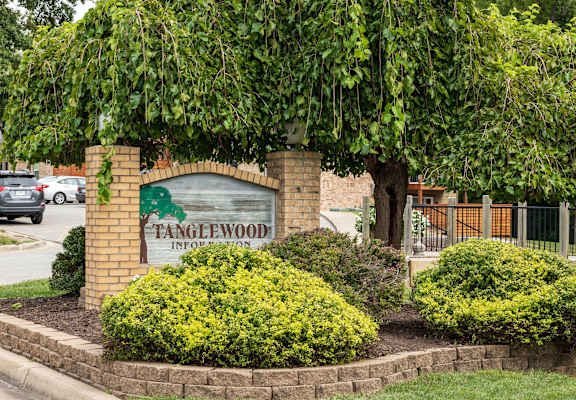 a sign for the fayettewood neighborhood in front of a tree