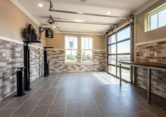 A spacious room with tiled floors and brick walls.