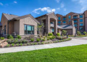 Thumbnail 35 of 78 - a building with a sidewalk and grass in front of it  at EdgeWater at City Center, Lenexa, 66219