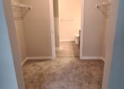 Thumbnail 7 of 27 - walk through closet with attached bathroom