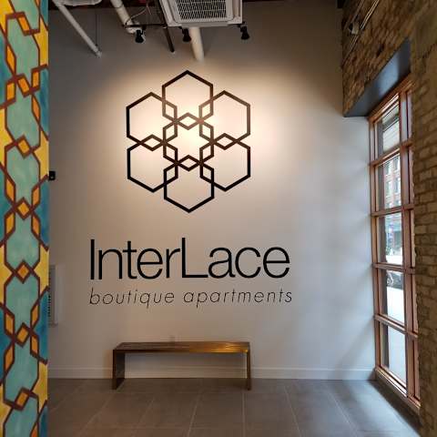 A wall with a logo that says InterLace boutique apartments.