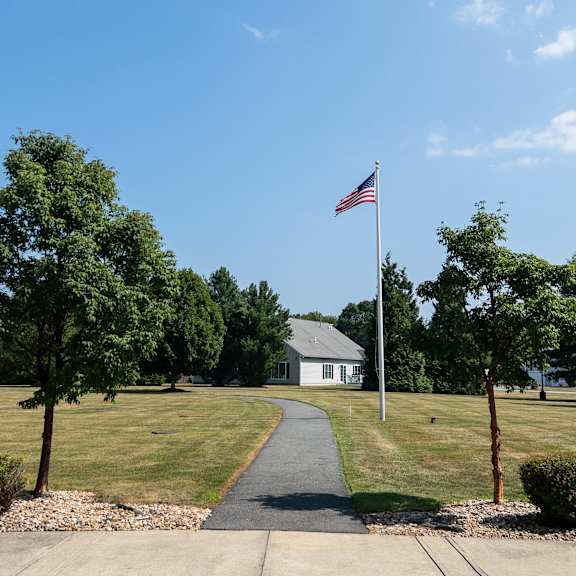 a real estate sign in front of a house photographic print