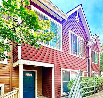 A house with a blue door and a red siding.