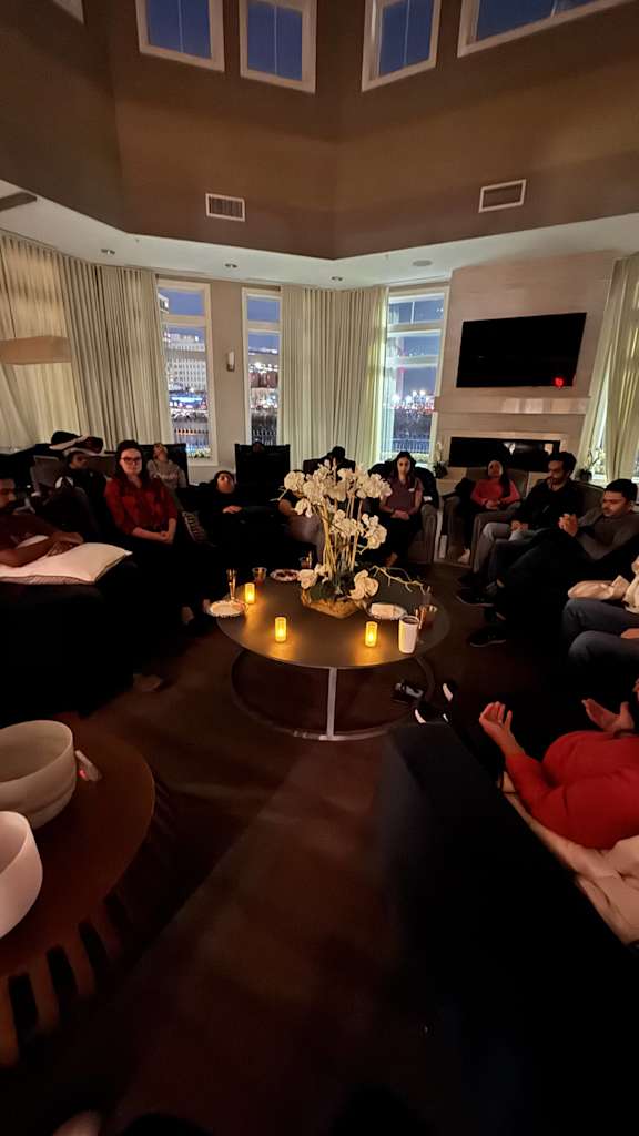 A group of people are sitting around a table in a room.