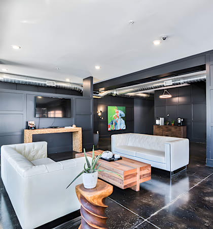 a living room with white couches and a coffee table