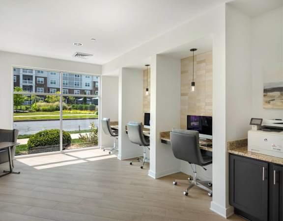 A modern home office with a view of a building outside the window.