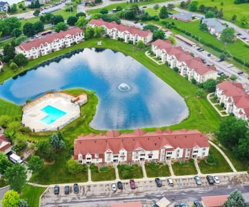 an aerial view of a large lake in front of a row of houses