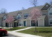 Thumbnail 1 of 4 - a row of houses with flowering trees in front of them