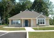 Thumbnail 4 of 4 - a small house in a parking lot with trees