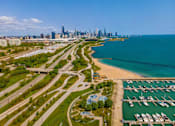 Thumbnail 57 of 59 - A cityscape with a beach and a marina.