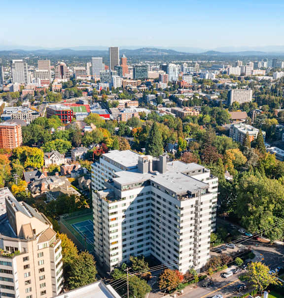 an aerial view of a city with tall buildings and trees