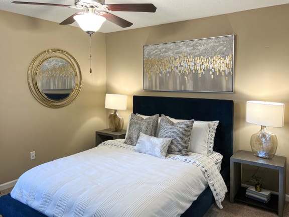 a bedroom with a large bed and a ceiling fan at Reserve Of Bossier City Apartment Homes in Louisiana 71111