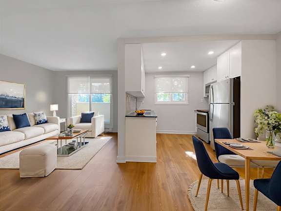 A modern kitchen with a dining table and chairs.