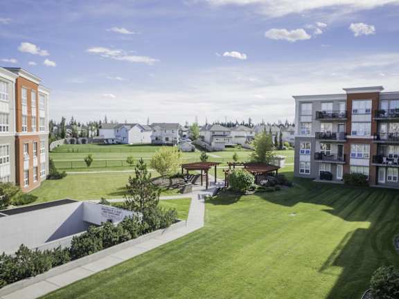 a rendering of an apartment community with a lawn and a park