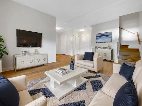 A living room with a white couch and a coffee table.