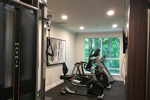 a home gym with exercise equipment and a window