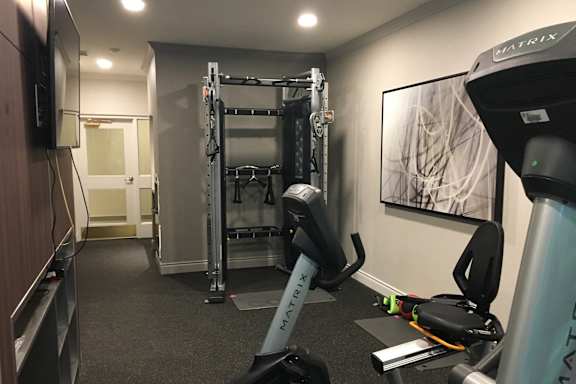 a gym with exercise equipment in a hotel room