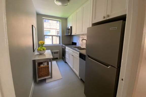 a kitchen with stainless steel appliances and white cabinets