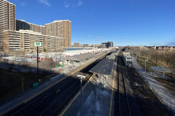 a view of the city from a train station with train tracks