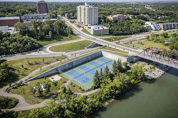 an aerial view of a tennis court in the city