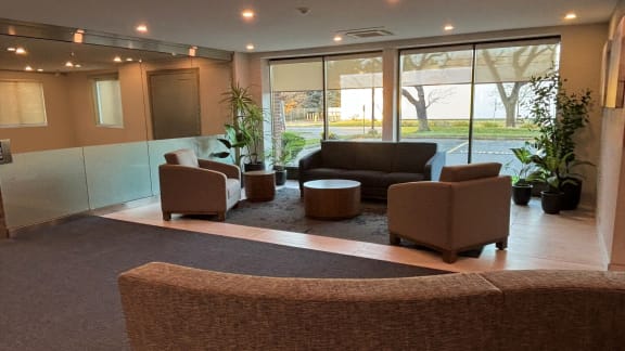 a lobby with couches and chairs and large windows