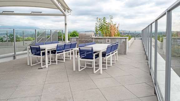A patio with a table and chairs under a white awning.