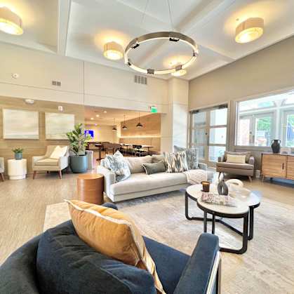 A spacious living room with a variety of furniture and decor.