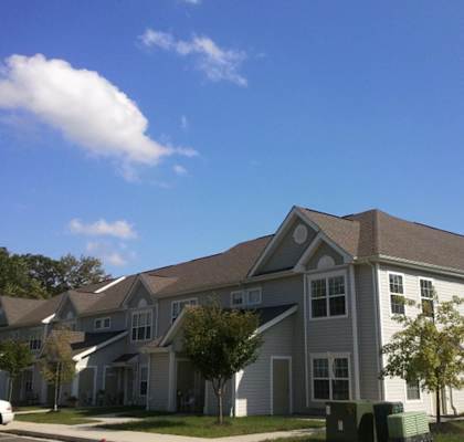 a gray house with a gray roof on a sunny day