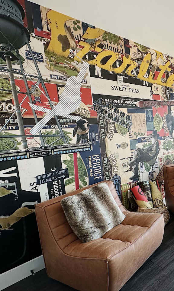 Common room with wall collage of posters at Cannery Flats, Montana