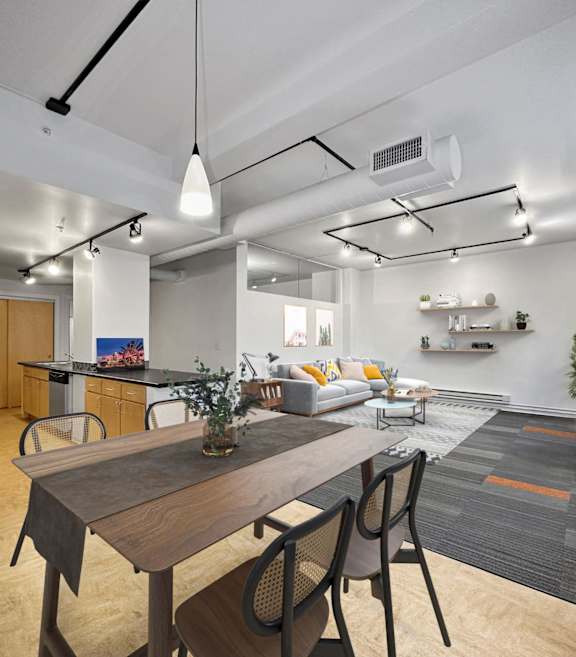 A modern kitchen with a dining table and chairs at The Des Moines Building Apartments, Des Moines, IA, 50309