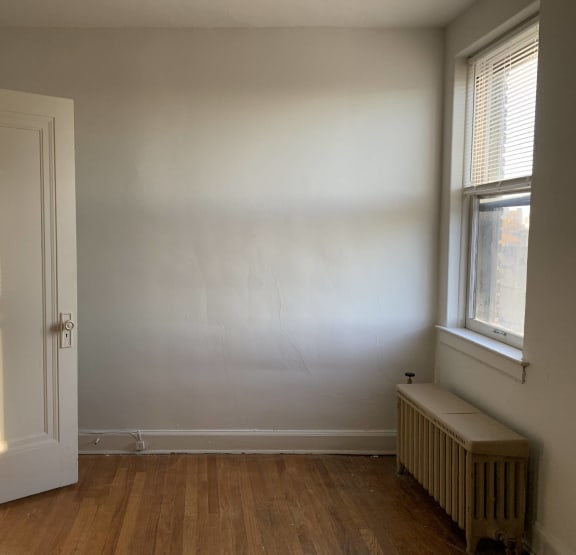a bedroom with a bed and bookshelves     and a chair