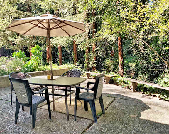 a patio with a table and chairs and an umbrella
