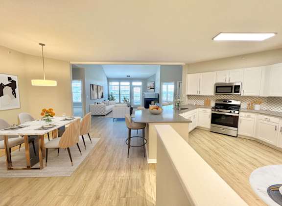 A modern kitchen with a dining table set for four.